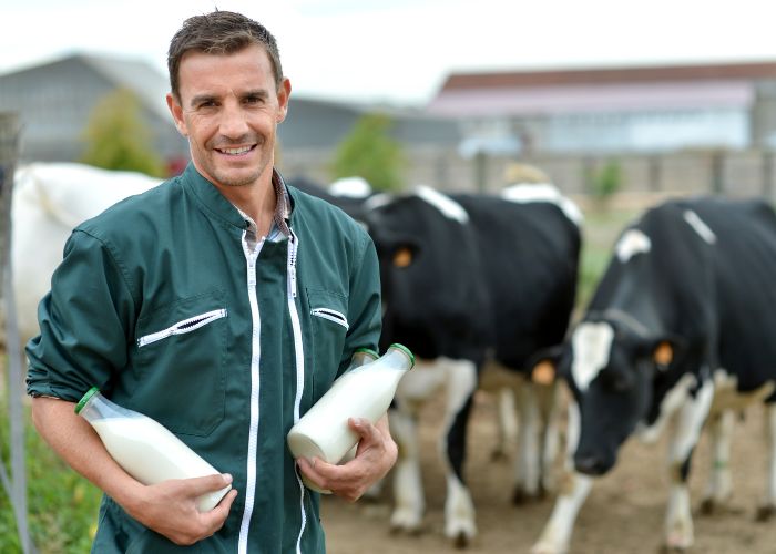 farmer holding raw milk cows pasture raised hello raw milk